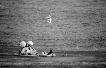 Fred Haise is winched to safety, after Odyssey's successful splashdown. Photo Credit: NASA