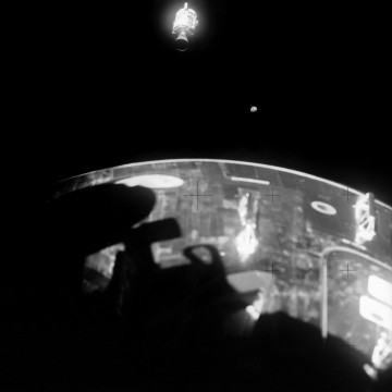 Surrounded by a cloud of gaseous oxygen, the damaged service module drifts into the distance after being jettisoned, late in the mission. The far-off Moon is also clearly visible. Photo Credit: NASA