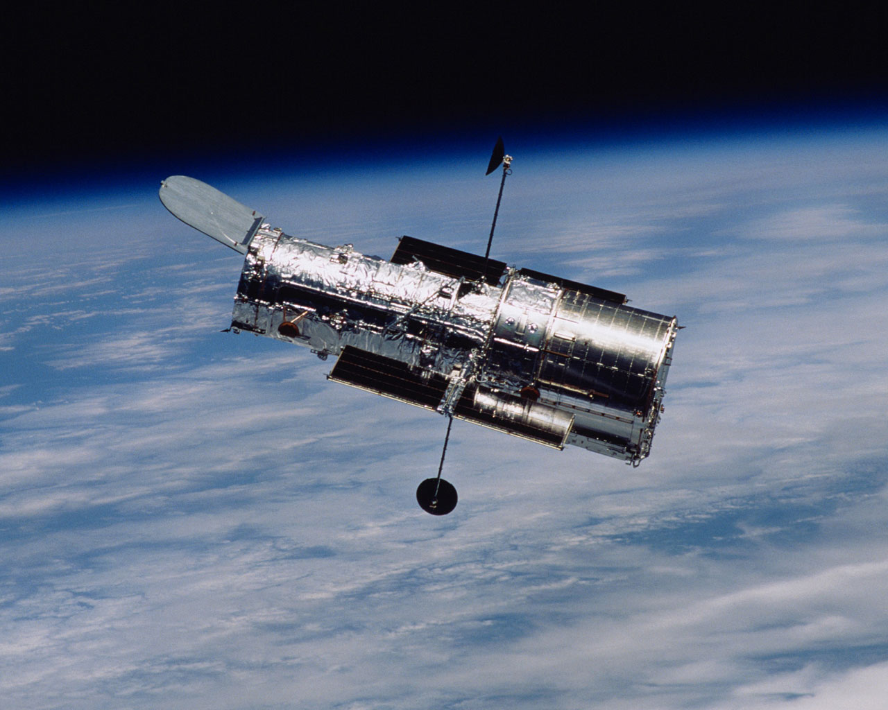 A photograph of the Hubble Space Telescope. taken by the crew of the STS-109 mission, following the successful completion of the fourth Hubble servicing mission in 2002. The iconic orbiting observatory, which celebrates 25 years of successful operation this month, has completely revolutionised our view of the Cosmos. Image Credit: NASA/STScI