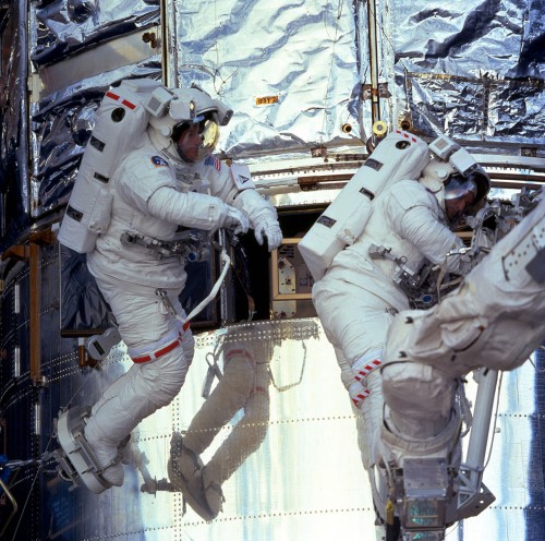 Astronauts Michael Foale and Claude Nicollier perform an EVA during the STS-103 mission, Hubble Servicing Mission 3A. Photo Credit: NASA