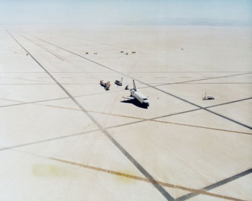 Columbia is approached by servicing vehicles after touchdown on the Edwards dry lakebed. Photo Credit: NASA