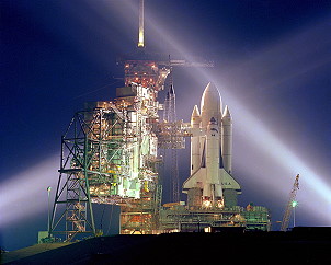 Resplendent in the glow of floodlights, Columbia stands ready on Pad 39A, mounted on her External Tank (ET) and twin Solid Rocket Boosters (SRBs). Photo Credit: NASA, via Joachim Becker/SpaceFacts.de