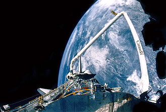 With the grandeur of Earth, from the highest orbit yet attained by the shuttle, providing a spectacular backdrop, the crew of STS-31 prepares to deploy Hubble on 25 April 1990. Photo Credit: NASA