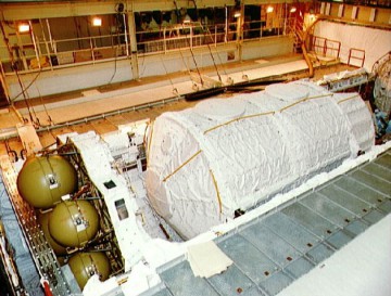 The Extended Duration Orbiter (EDO) "wafer" is pictured in the aft end of Columbia's payload bay, alongside the Spacelab module, during STS-50 pre-launch processing. Photo Credit: NASA