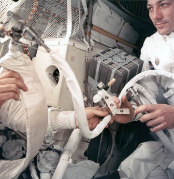 Jack Swigert handles one of the impromptu carbon dioxide scrubbers, late in the mission. Photo Credit: NASA