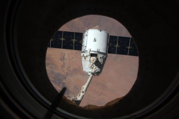 The CRS-6 Dragon spacecraft in the pre-release position, still attached to Canadarm2. Photo Credit: Samantha Cristoforetti/Twitter/NASA