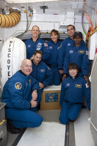 The STS-131 is pictured at the side hatch of Discovery. Clockwise from bottom left are Alan Poindexter, Jim Dutton, Clay Anderson, Dottie Metcalf-Lindenburger, Rick Mastracchio, Stephanie Wilson and Naoko Yamazaki. Photo Credit: NASA