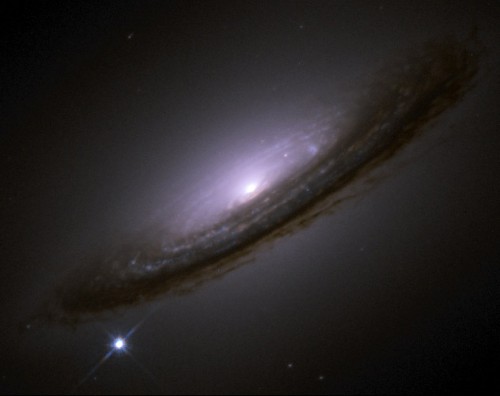 A Hubble image of the type Ia supernova SN 1994D (lower left) that exploded in the galaxy NGC 4526. By studying more than a 50 such supernovae in distant galaxies with the Hubble Space Telescope, astronomers were able to determine that the expansion of the Universe is accelerating. Image Credit: High-Z Supernova Search Team/HST/NASA 