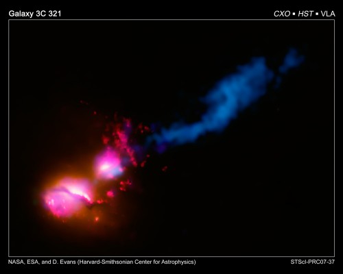 A composite image showing the jet from a black hole at the center of a galaxy striking the edge of its neighboring galaxy, in the system known as 3C 321. NASA, ESA, D. Evans (Harvard-Smithsonian Center for Astrophysics), [X-ray: NASA/CXC/CfA/D.Evans et al.; Optical/UV: NASA/STScI; Radio: NSF/VLA/CfA/D.Evans et al., STFC/JBO/MERLIN]