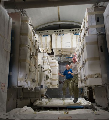 The size of the Leonardo PMM is apparent in this image following its installation in February 2011, showing U.S. astronauts Steve Lindsey (left) and Scott Kelly aboard the module. Photo Credit: NASA