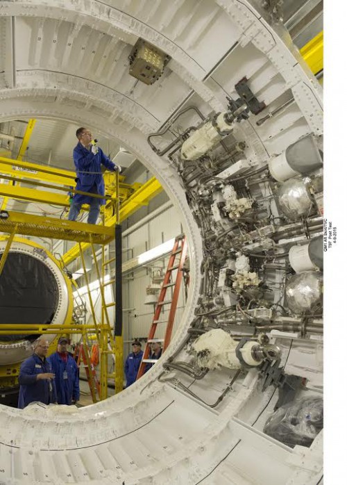 Orbital ATK technicians inspect the SLS Qualification Motor-1 (QM-1) booster after a successful test fire on March 11, 2015. Photo Credit: Orbital ATK