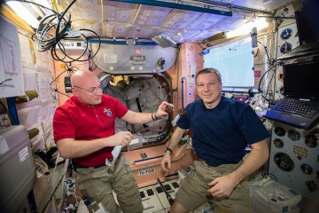 Terry Virts (right) and Scott Kelly share a snack inside the Unity node on 15 May. This module was one of the earliest delivered to the International Space Station (ISS) and will soon be a hive of activity as the Leonardo PMM relocation maneuver gets underway. Photo Credit: NASA