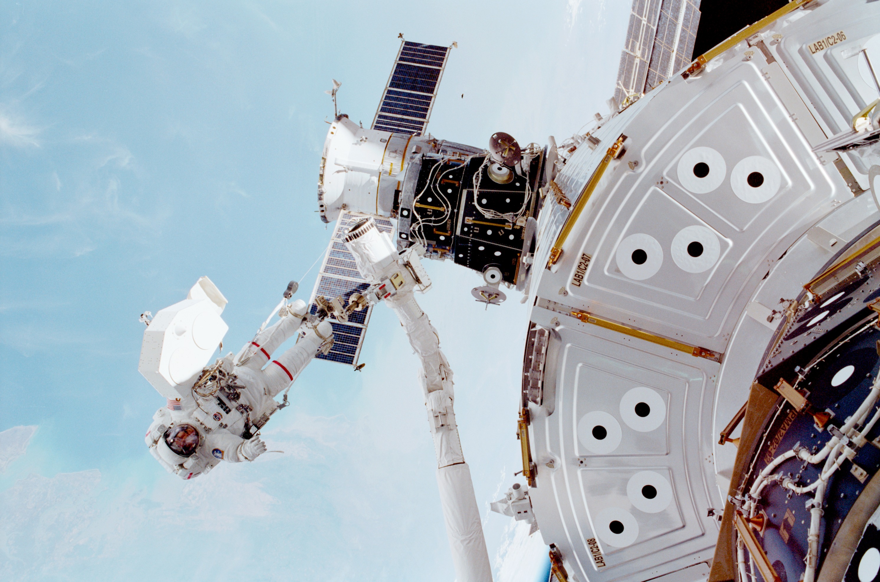 Jim Voss is pictured at the end of Discovery's Remote Manipulator System (RMS) mechanical arm, during the longest EVA ever undertaken, in March 2001. Photo Credit: NASA