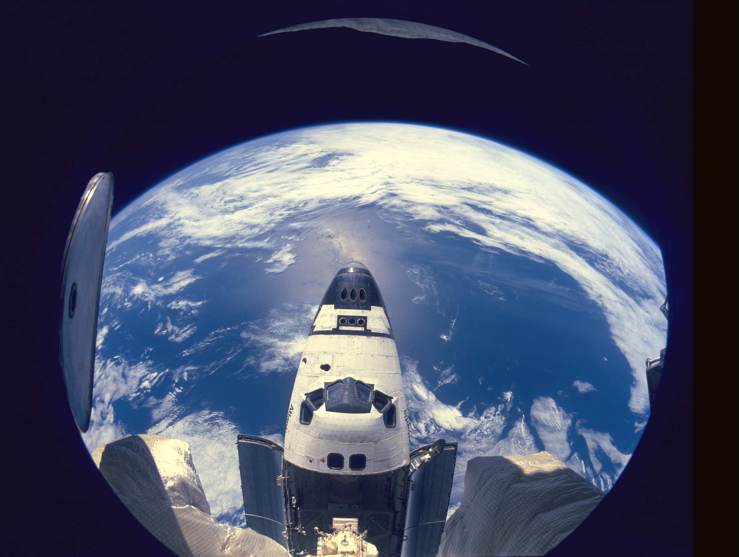 Space Shuttle Atlantis, as viewed through one of Mir's windows, during the extraordinary docking mission in June 1995. Photo Credit: NASA