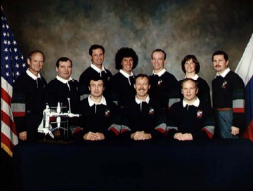 The combined crews of Mir and STS-71. From row (from left) are Vladimir Dezhurov, Robert "Hoot" Gibson and Anatoli Solovyov, with Norm Thagard, Gennadi Strekalov, Greg Harbaugh, Ellen Baker, Charlie Precourt, Bonnie Dunbar and Nikolai Budarin standing. Photo Credit: NASA