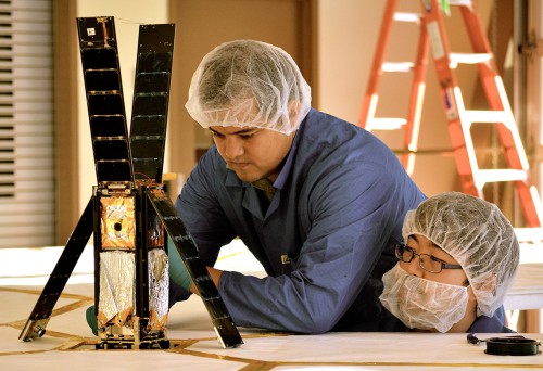 LightSail team members Alex Diaz (left) and Riki Munakata (Right) prepare the spacecraft for a sail deployment test. Photo Credit and Caption: The Planetary Society 