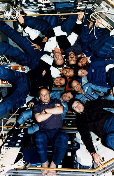 The STS-71 and Mir crews gather for a group photograph inside the Spacelab module aboard Atlantis' payload bay. Photo Credit: NASA