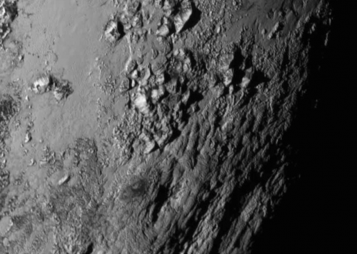 New close-up images of a region near Pluto’s equator reveal a giant surprise -- a range of youthful mountains rising as high as 11,000 feet (3,500 meters) above the surface of the icy body. Credits: NASA/JHU APL/SwRI