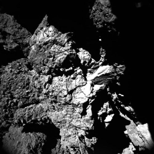 From ESA: "This well-lit image was acquired by Philae’s CIVA camera 4 at the final landing site Abydos, on the small lobe of Comet 67P/Churyumov–Gerasimenko, on 13 November 2014. The image shows one of the CONSERT antennas in the foreground, which seems to be in contact with the nucleus." CIVA's seven cameras captured images of Philae's position at its final landing site, Abydos. Image Credit: ESA/Rosetta/Philae/CIVA