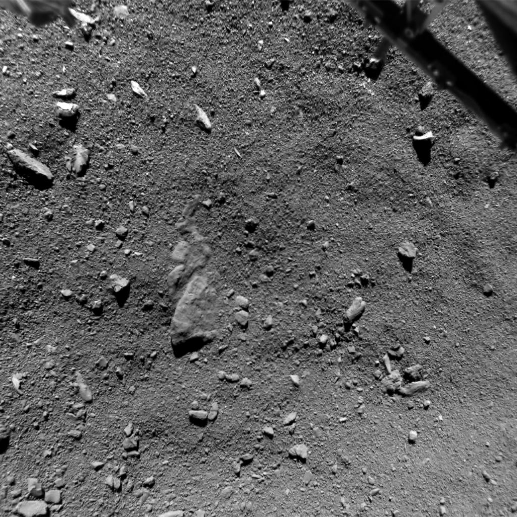 From ESA: "This image was taken by Philae’s ROsetta Lander Imaging System, ROLIS 9 m above the Agilkia landing site on the small lobe of Comet 67P/Churyumov–Gerasimenko. The image was acquired at 15:33:58 GMT on 12 November 2014. The image measures 9.7 m across and the image scale is 0.95 cm/pixel. Part of Philae’s landing gear can be seen in the top corners." Image Credit: ESA/Rosetta/Philae/ROLIS/DLR