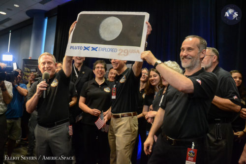 Dr. Alan Stern (holding banner at left) and the New Horizons mission team celebrates New Horizons' closest approach to Pluto at 7:49 a.m. EDT on July 14, 2015. Photo Credit: Elliot Severn / AmericaSpace