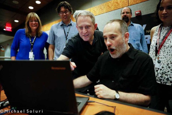 Science team members for the New Horizons mission at the Johns Hopkins University Applied Physics Lab in Laurel, MD, react enthusiastically to the latest image that was received by New Horizons on July 10. Image Credit: Michael Soluri