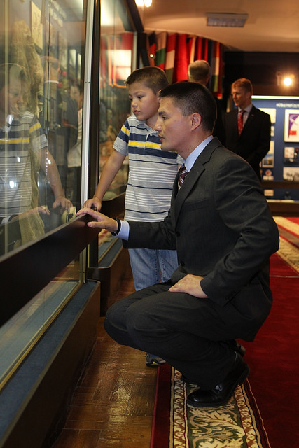Kjell Lindgren explains one of the historic artifacts in the Gagarin Museum at the Star City cosmonauts' training center to his son. Photo Credit: NASA