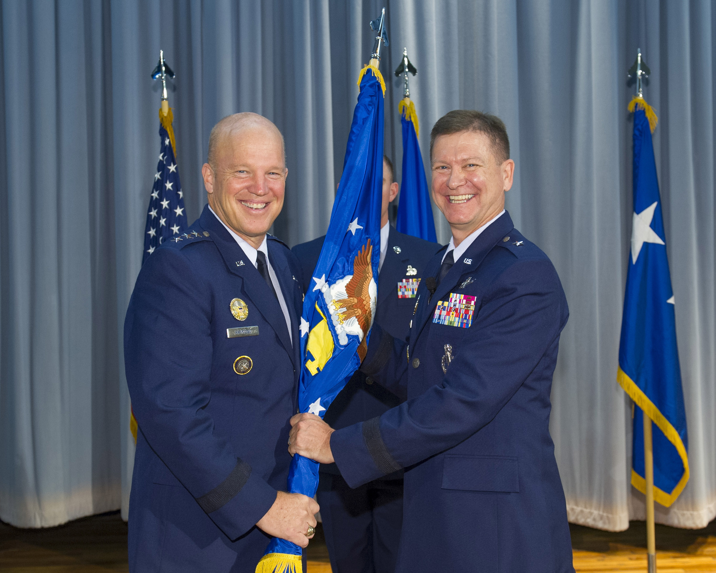 Lt. Gen. John W. "Jay" Raymond, commander, 14th Air Force (Air Forces Strategic) and Joint Functional Component Command for Space, presents Brig. Gen. Wayne Monteith, 45th Space Wing commander during a change of command ceremony, Aug. 4, 2015, at Patrick Air Force Base, Florida. Changes of command are a military tradition representing the transfer of responsibilities from the presiding officials to the upcoming official. Photo and Caption Credit: U.S. Air Force/Matthew Jurgens (Released) 