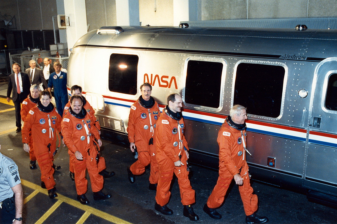 Commander Vance Brand leads his crew out of the Operations & Checkout (O&C) Building, just before midnight on 1/2 December 1990, bound for Pad 39B and Columbia. Photo Credit: NASA, via Joachim Becker/SpaceFacts.de