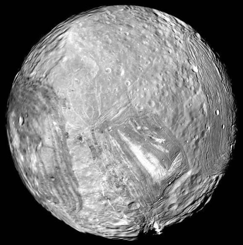 Uranus' moon Miranda shows signs of past geological activity, with deep canyons and other chaotic terrain. Photo Credit: NASA/JPL-Caltech