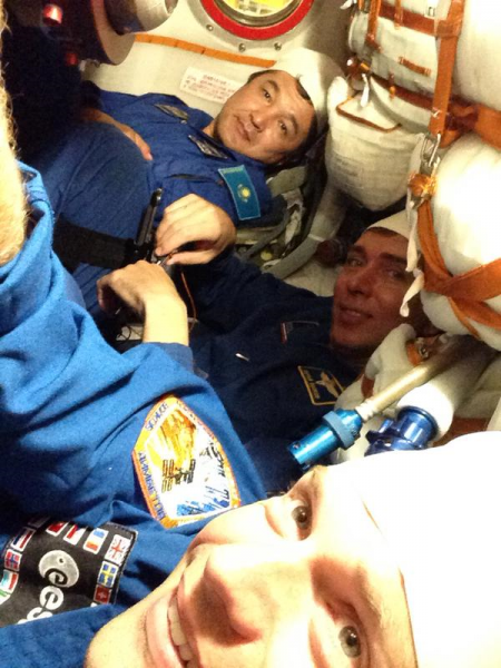 Aidyn Aimbetov (background), Sergei Volkov (center) and Andreas Mogensen (foreground) participate in trials aboard Soyuz TMA-18M at Baikonur, last week. Photo Credit: Andreas Mogensen/Twitter