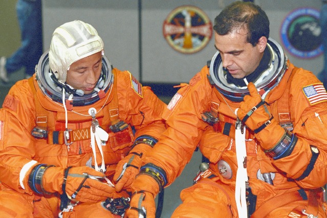 Ed Lu (left) and Rick Mastracchio check training versions of their shuttle Launch and Entry Suits (LES) in April 2000. Photo Credit: NASA
