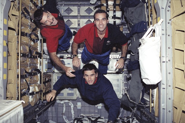 Astronauts Dan Burbank (left), Rick Mastracchio (right) and Yuri Malenchenko (lower) are pictured aboard the Spacehab Double Module in Atlantis' payload bay, where the bulk of cargo for transfer to the space station was situated. Photo Credit: NASA