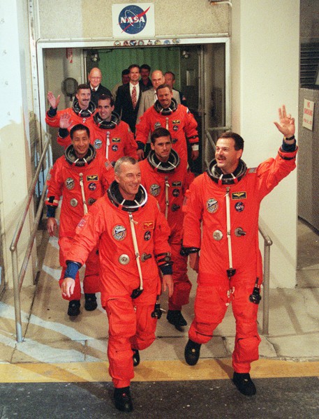 Terry Wilcutt (front left) and Scott Altman (front right), lead their crew out of the Operations & Checkout (O&C) Building on 8 September 2000, ready to re-initiate assembly of the International Space Station (ISS). Photo Credit: NASA