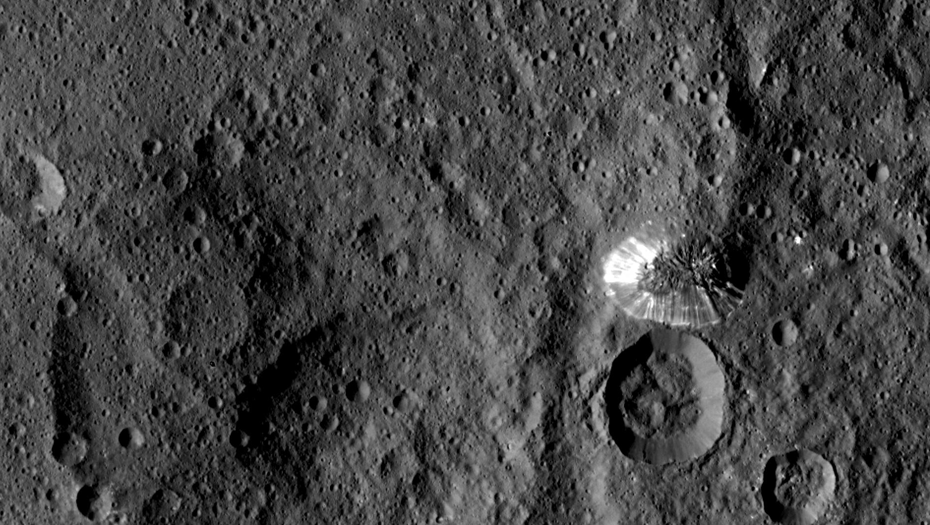 From NASA/JPL: "The Lonely Mountain The Lonely Mountain NASA's Dawn spacecraft spotted this tall, conical mountain on Ceres from a distance of 915 miles (1,470 kilometers). The mountain, located in the southern hemisphere, stands 4 miles (6 kilometers) high. Its perimeter is sharply defined, with almost no accumulated debris at the base of the brightly streaked slope." This image was taken August 19. Image Credit: NASA/JPL-Caltech/UCLA/MPS/DLR/IDA