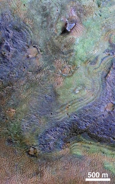 Orbital view of Nili Fossae, where the largest known deposit of carbonates is located (green areas). Image Credit: NASA/JPL-Caltech/JHUAPL/Univ. of Arizona