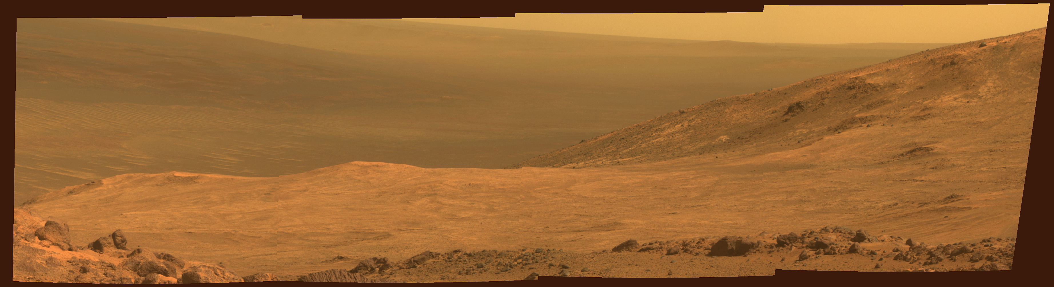 An overview of Marathon Valley, seen from Opportunity on March 13, as the rover was positioned at the Valley's northern side, along the western rim of Endeavour Crater. The scene spans from east, at left, to southeast. Image Credit: NASA/JPL-Caltech/Cornell Univ./Arizona State Univ.