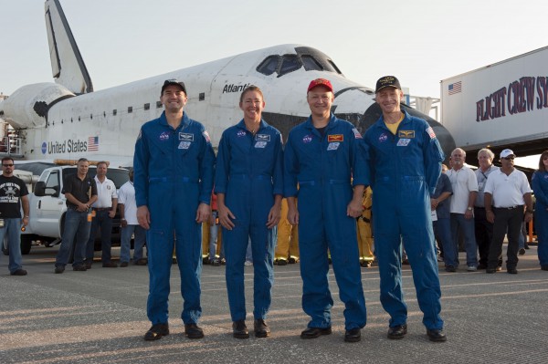 Atlantis poses on the runway with the 33rd crew whose lives she guarded from launch through landing. From left are Rex Walheim, Sandy Magnus, Doug Hurley and Chris Ferguson. Photo Credit: NASA/Kim Shiflett