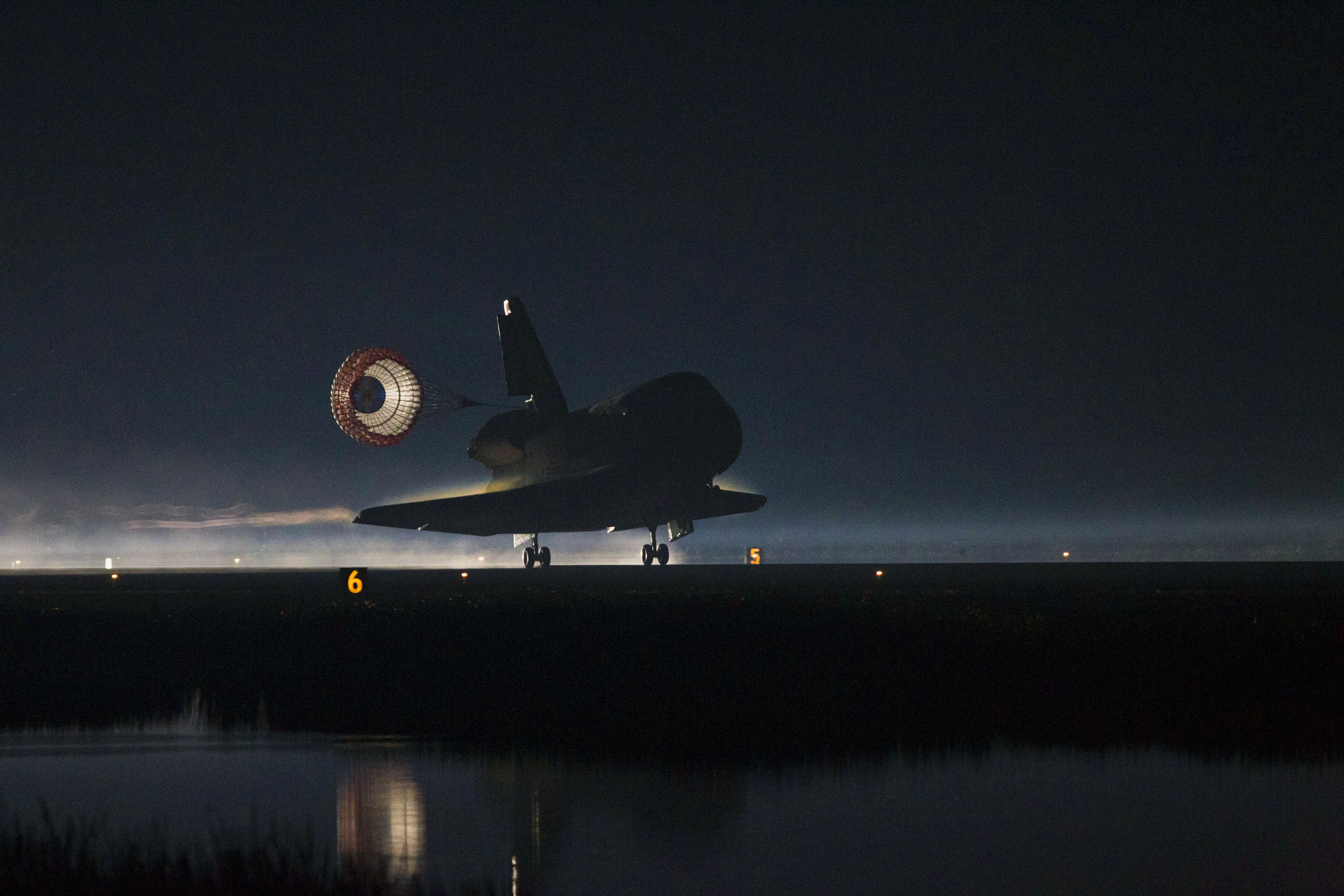 Atlantis alights on Runway 15 at the Shuttle Landing Facility (SLF) at the Kennedy Space Center (KSC) in Florida at 5:57 a.m. EDT on 21 July 2011, wrapping up a remarkable 33-mission career. Photo Credit: NASA/Kenny Allen