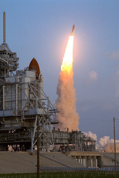 Discovery rockets away from Pad 39B on 6 October 1990, with her sister ship Columbia in residence at Pad 39A in the foreground. Photo Credit: NASA, via Joachim Becker/SpaceFacts.de