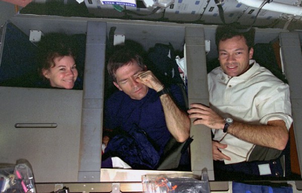 Blue Team members Catherine "Cady" Coleman, Fred Leslie and Mike Lopez-Alegria bail out of their sleep stations in Columbia's middeck, ahead of another 12 hours in support of the second United States Microgravity Laboratory (USML-2). Photo Credit: NASA 