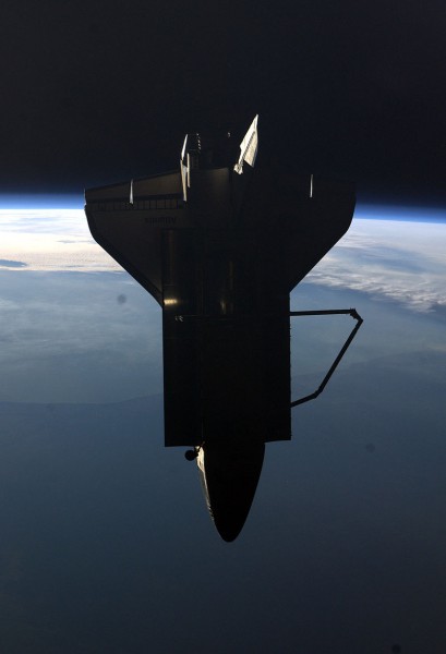 Silhouetted against the Home Planet, Atlantis withdraws from the International Space Station (ISS) in the closing days of STS-135 in July 2011. Photo Credit: NASA