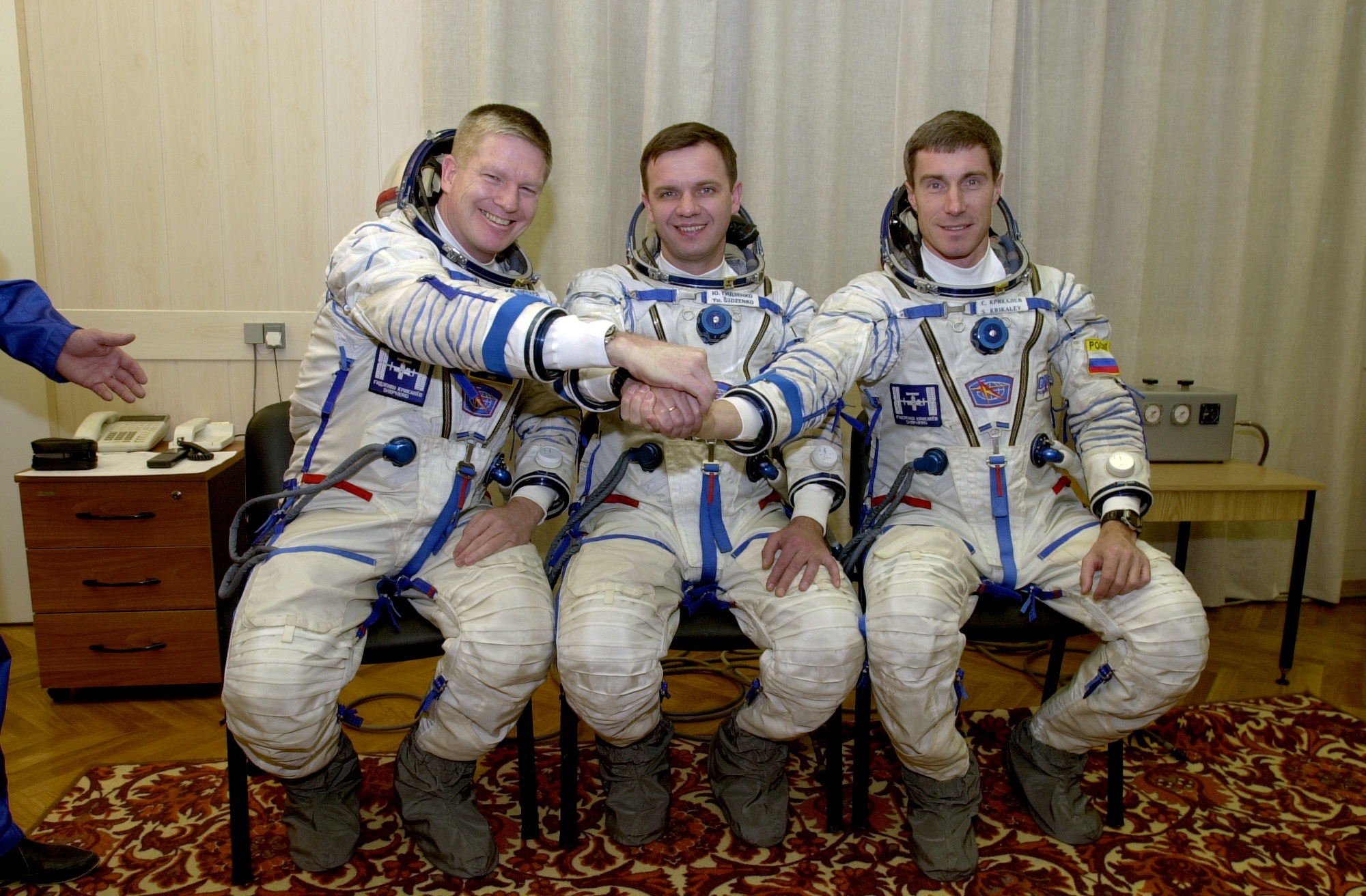 Clad in their Sokol ("Falcon") launch and entry suits, Expedition 1 crew members (from left) Bill Shepherd, Yuri Gidzenko and Sergei Krikalev began the permanent occupancy of the International Space Station (ISS), 15 years ago, this week. Photo Credit: NASA
