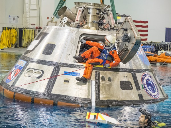 NASA astronaut Suni Williams exits a test version of the Orion spacecraft in the agency’s Neutral Buoyancy Lab in Houston. The testing is helping NASA identify the best ways to efficiently get astronauts out of the spacecraft after deep space missions. Caption and Credit: NASA 