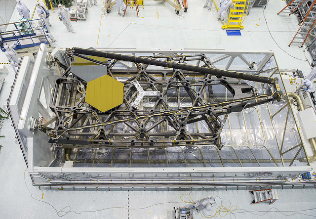 Bird's eye view of NASA Goddard's cleanroom and JWST's test backplane and mirrors sitting in their packing case, prior to shipping to Johnson Space Center for cryo testing earlier this year. Photo Credit: NASA/Chris Gunn