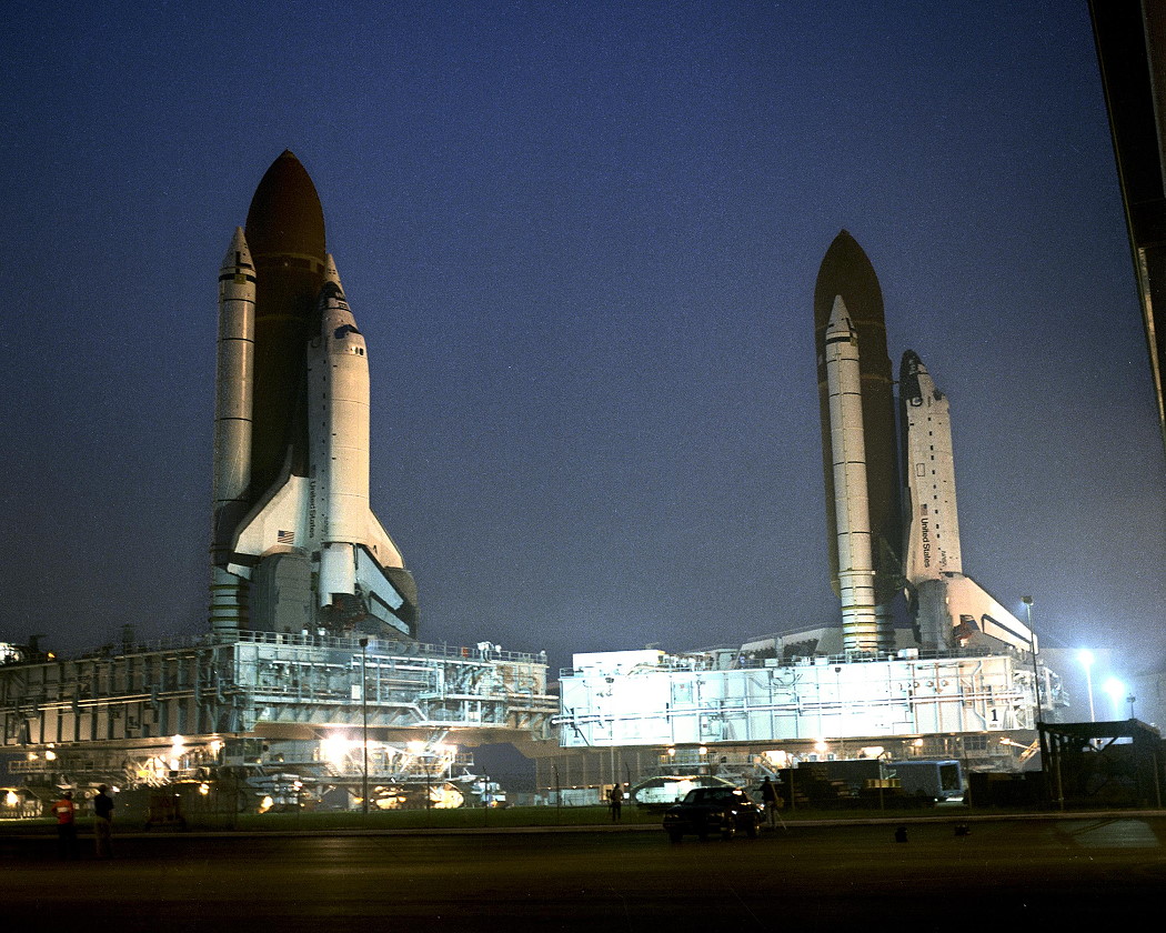 The historic "rollback" of the STS-38 stack (right) on 9 August 1990, which occurred as the STS-35 stack was returning to the pad. Photo Credit: NASA, via Joachim Becker/SpaceFacts.de