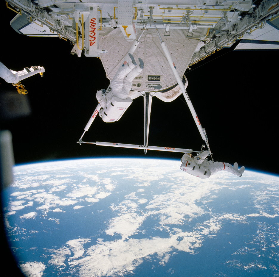 In the earliest EVA demonstration of building a space station, Jerry Ross and Woody Spring assemble the EASE tetrahedron in Atlantis' payload bay. Their flight, Mission 61B, began 30 years ago, next week. Photo Credit: NASA, via Joachim Becker/SpaceFacts.de