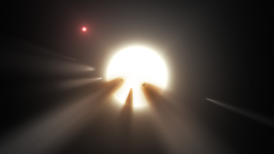 An artist's illustration of cometary fragments passing in front of a star. A new study based on data gathered by NASA's Spitzer Space Telescope suggests that the anomalous dips in brightness that have been observed around the star KIC 8462852 are caused by the fragmentation of similar cometary fragments. Image Credit: NASA/JPL-Caltech