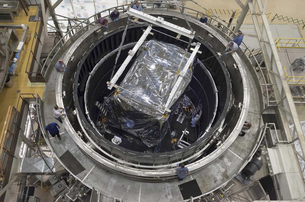 Overhead view of the thermal vacuum chamber at Goddard shows engineers readying the Integrate Science Instrument Module (ISIM) that was just lowered into the chamber for its final cryogenic test at Goddard. Image Credit: NASA/Chris Gunn