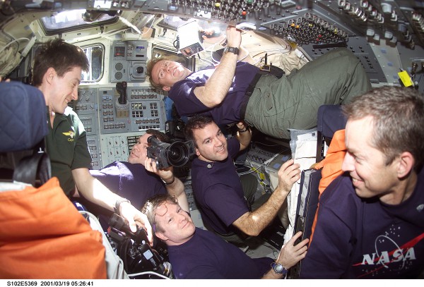 Pictured with members of the STS-102 crew in Discovery's crowded flight deck, Expedition 1 crewmen Sergei Krikalev (left) and Bill Shepherd (lower) seem jubilant to be approaching their return to Earth. Photo Credit: NASA